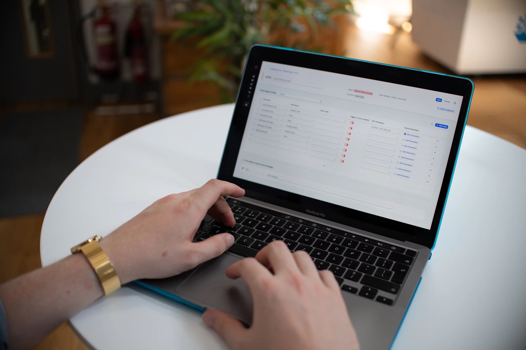 Hands using a laptop to review a business spreadsheet.