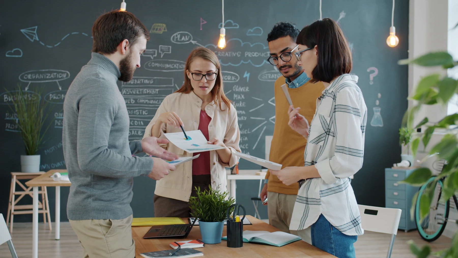 A small team planning a project together around a table.