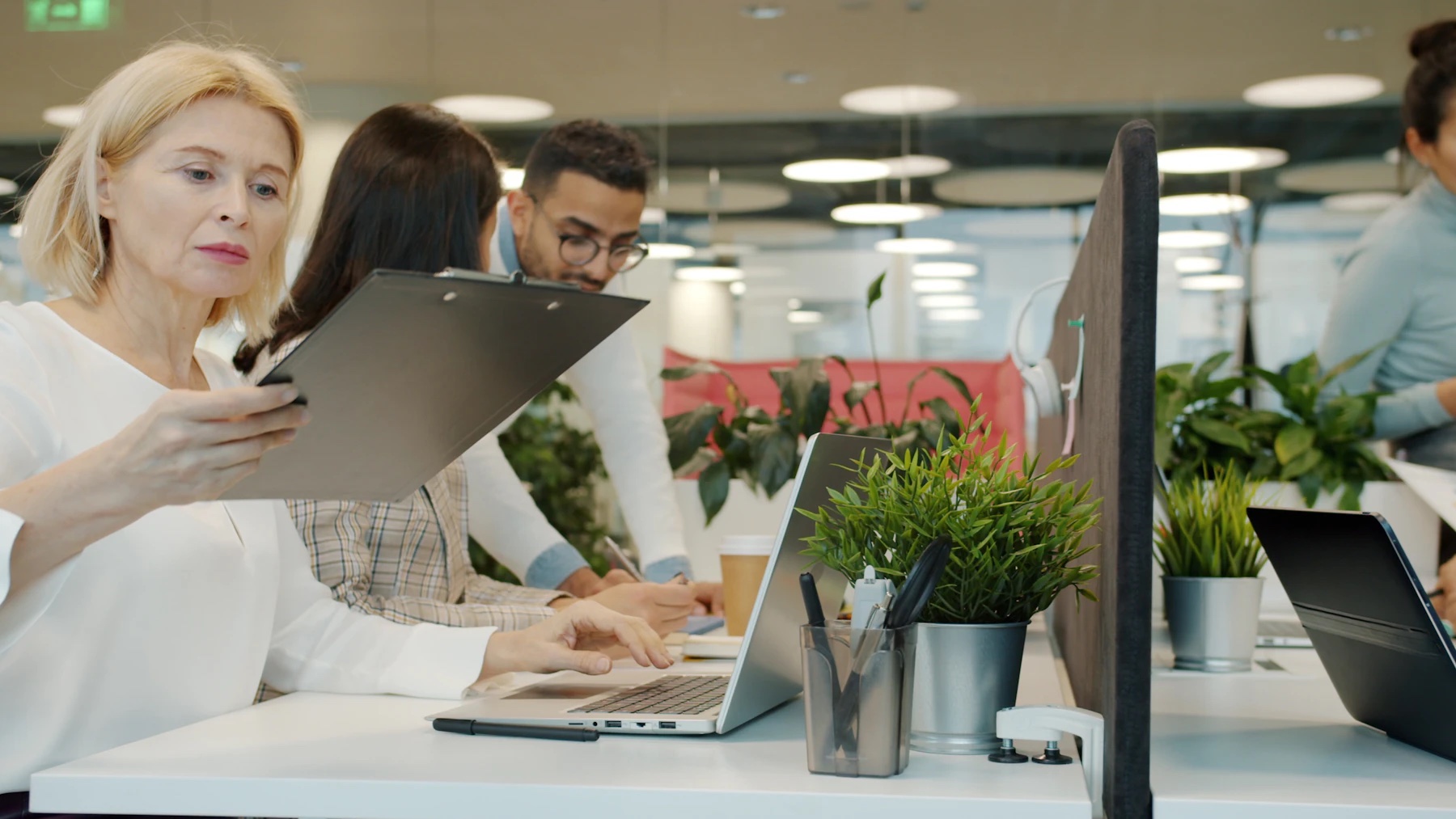 Colleagues reviewing work together in a modern office.